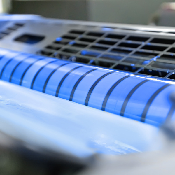 close-up of a blue UV curing lamp in a printing press close-up of a blue UV curing lamp in a printing press